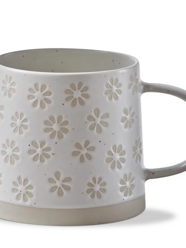cream mug with stamped flower pattern