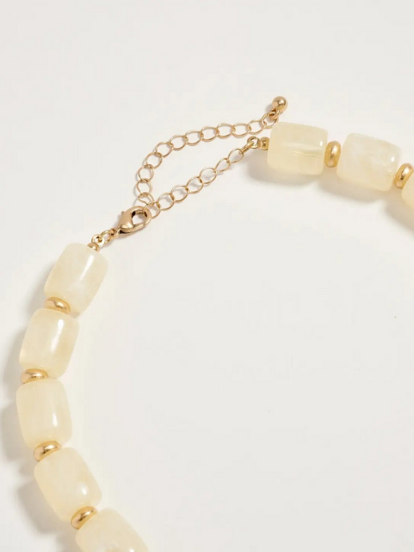 neutral chunky beaded necklace with large gold seashell pendant