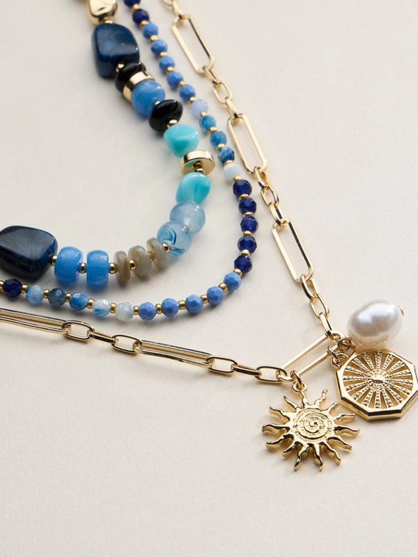 blue layered beaded and chain necklace with sun and pearl charms