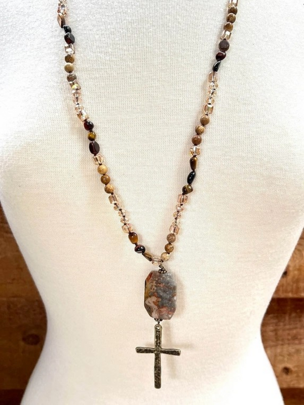 brown stone with large cross necklace
