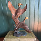 Two Brass Ducks in Flight