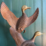 Two Brass Ducks in Flight