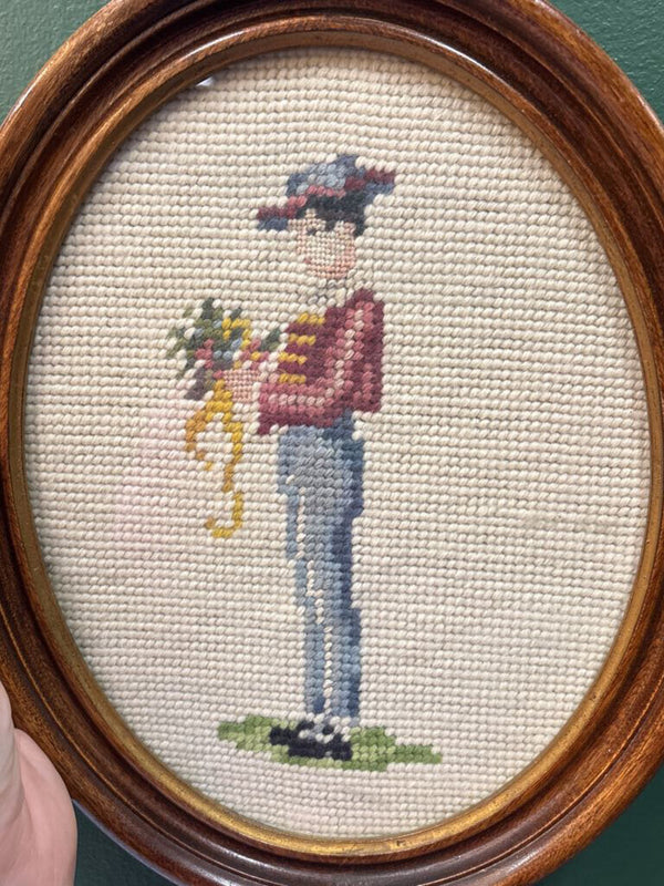 Man Holding Flowers Framed Oval Needlepoint