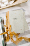 notes oak green paper with camel ribbon