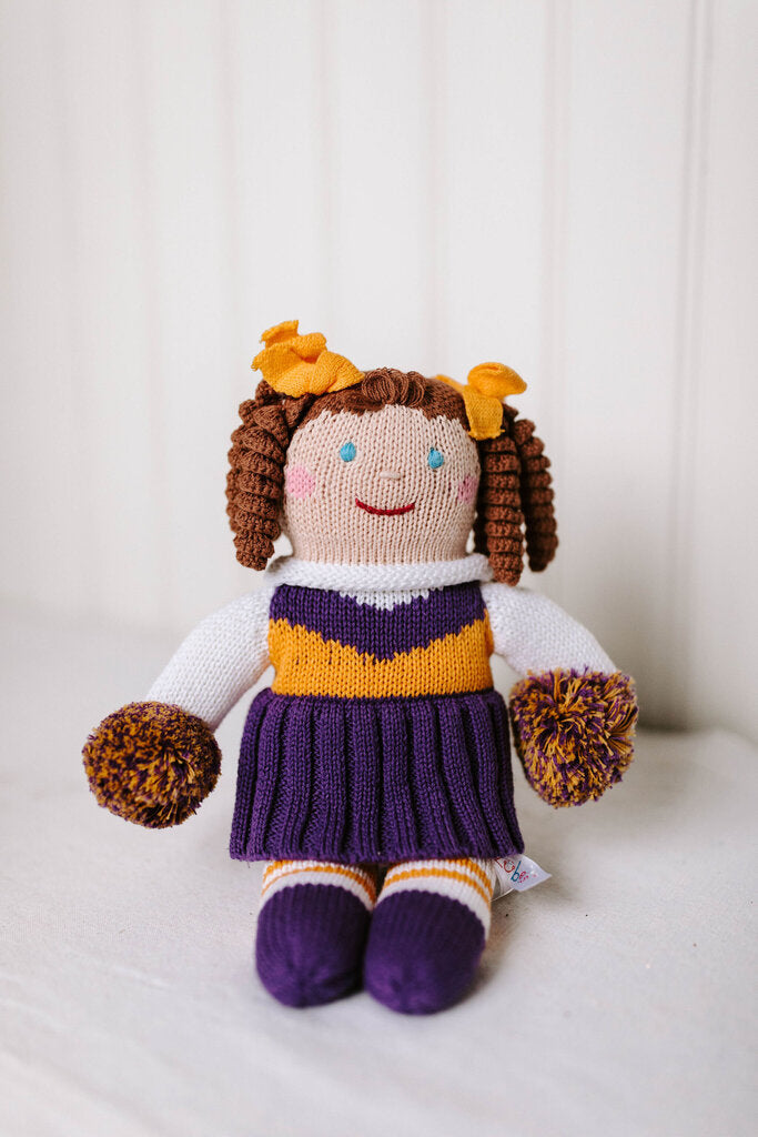 purple and gold cheerleader doll