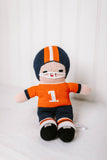 orange and navy football player doll