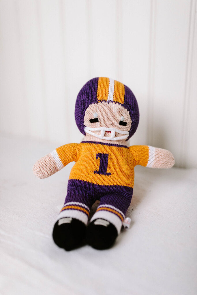 purple and gold football player doll