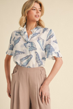 off white top with blue seashell print