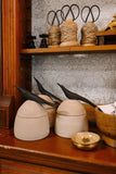 large clay canister with wood bird handle