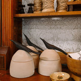 large clay canister with wood bird handle