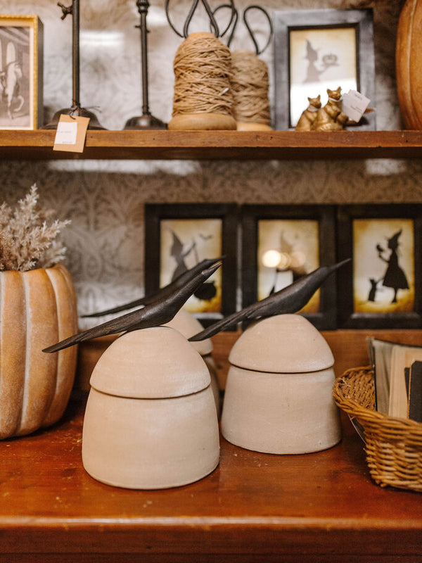 large clay canister with wood bird handle