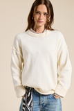 ecru sweater with ribbed crew neckline and ribbed sleeve cuffs