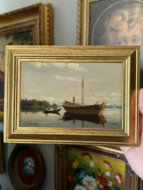 vintage style man fishing boat art print in a frame