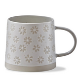 cream mug with stamped flower pattern