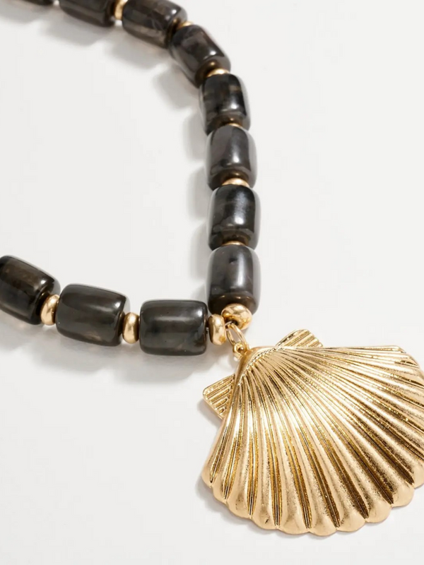 black chunky beaded necklace with large gold seashell pendant