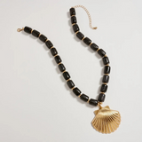 black chunky beaded necklace with large gold seashell pendant