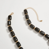 black chunky beaded necklace with large gold seashell pendant