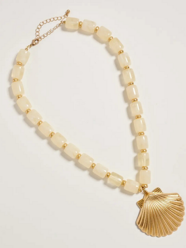 neutral chunky beaded necklace with large gold seashell pendant