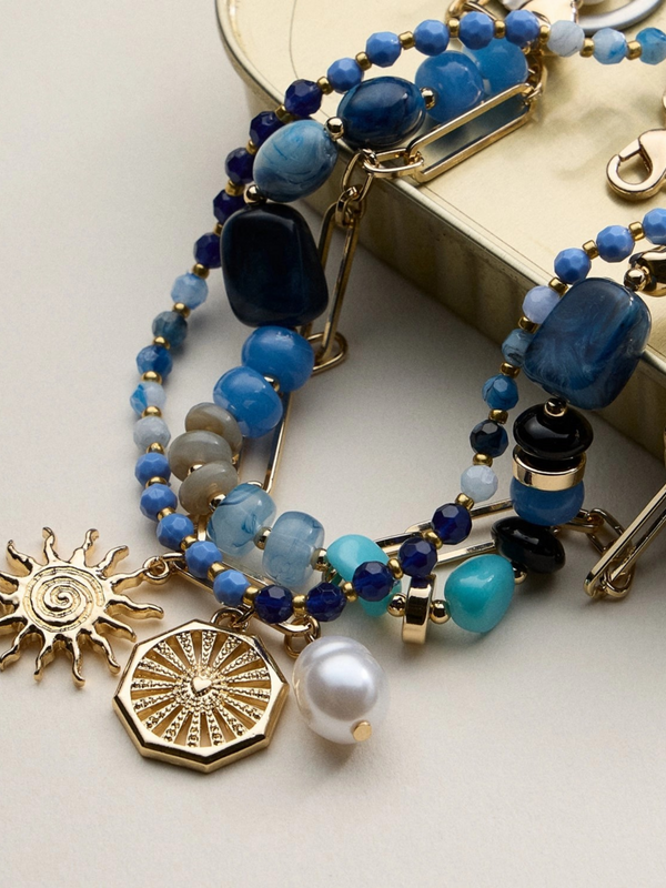 blue layered beaded and chain necklace with sun and pearl charms