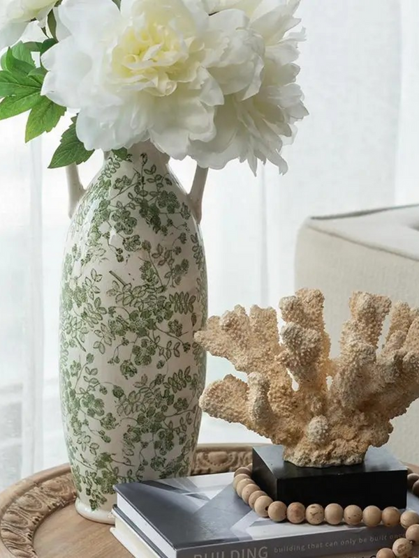 white ceramic vase with green florals and handles