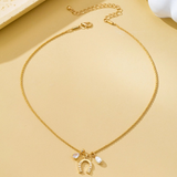 pave horseshoe and pearl drop charm necklace