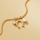 pave horseshoe and pearl drop charm necklace