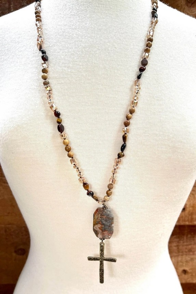 brown stone with large cross necklace