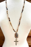 brown stone with large cross necklace