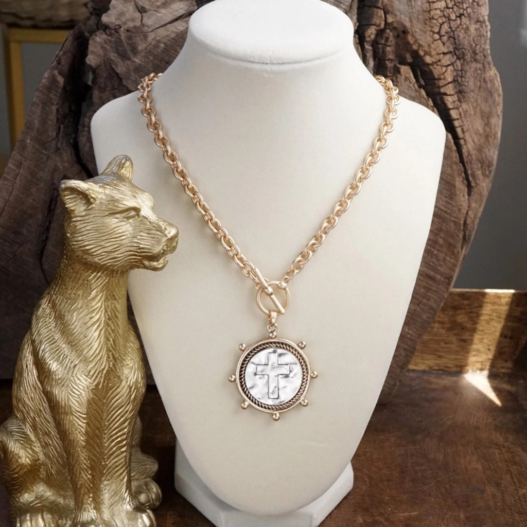 worn gold cross coin chain necklace with front toggle closure