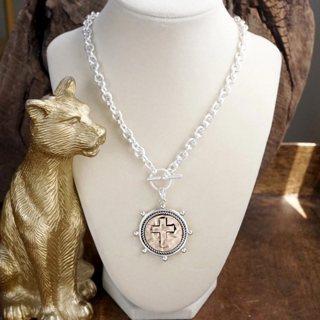 worn silver cross coin chain necklace with front toggle closure