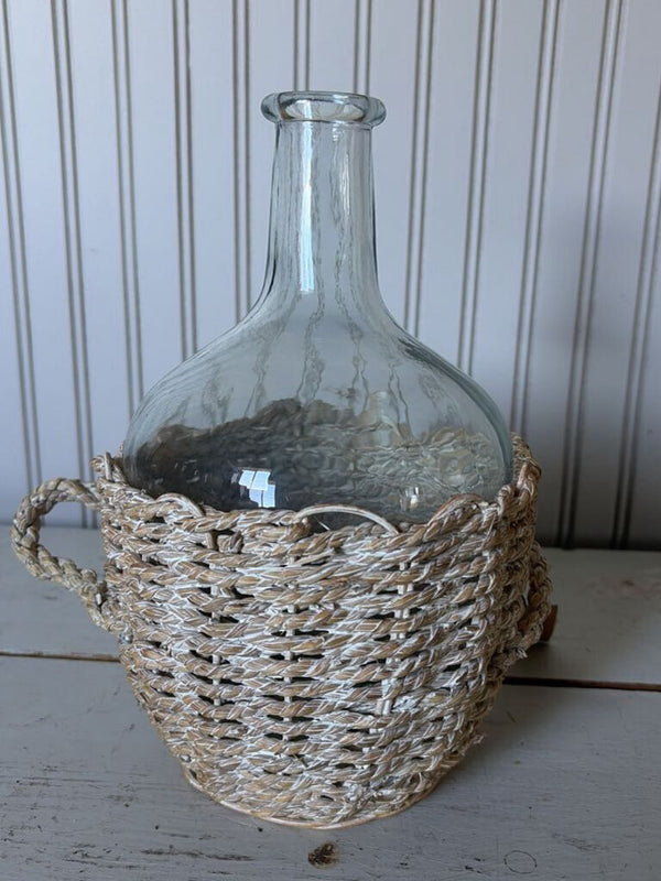 glass bottle in woven basket