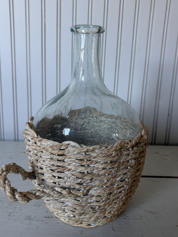 glass bottle in woven basket
