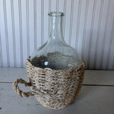 glass bottle in woven basket