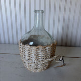 glass bottle in woven basket