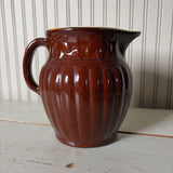 large brown pottery pitcher