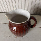 large brown pottery pitcher