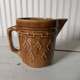 small brown pottery pitcher