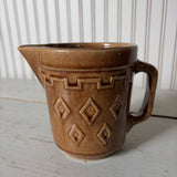 small brown pottery pitcher