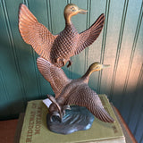 Two Brass Ducks in Flight