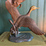 Two Brass Ducks in Flight