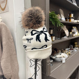beige and black bow pom hat
