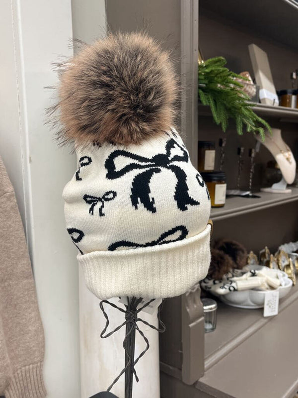 beige and black bow pom hat
