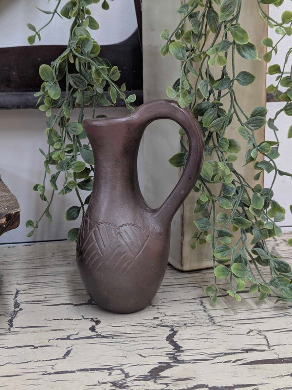 Signed Eastern Band Cherokee pottery, Swimmer family with original tag