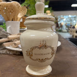 small white and gold urn with lid