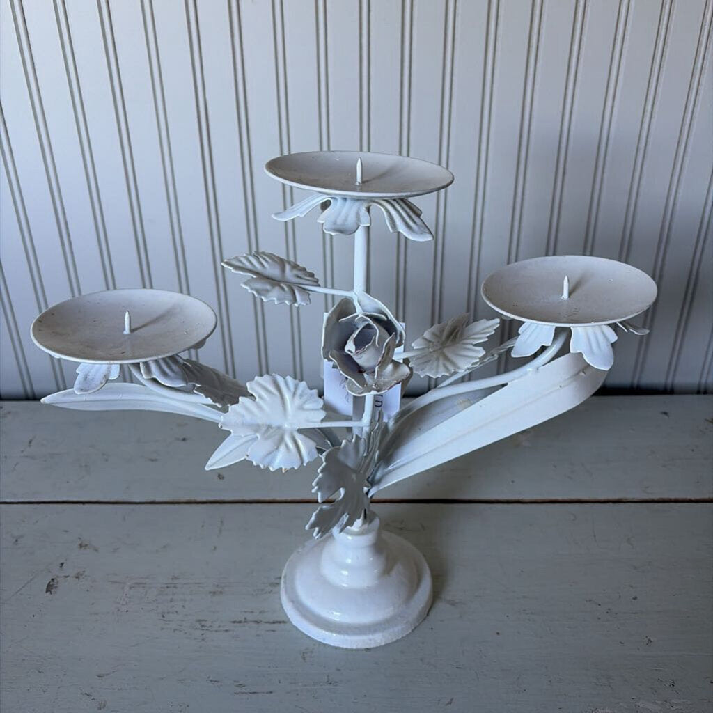 white metal triangle candle holder with metal flower