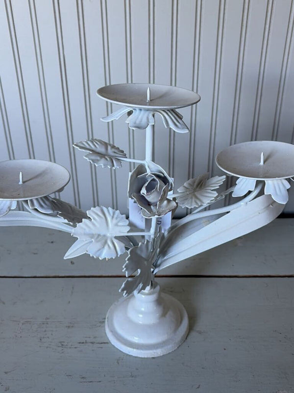 white metal triangle candle holder with metal flower
