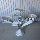 white metal triangle candle holder with metal flower