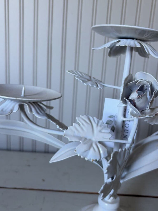 white metal triangle candle holder with metal flower