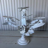 white metal triangle candle holder with metal flower