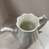 white ribbed pottery pitcher